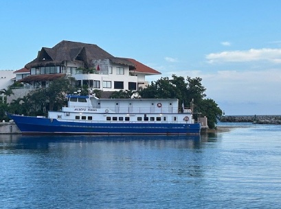 The vessel Mercy lying alongside a quay in Mexico, blue hull and white superstructure.